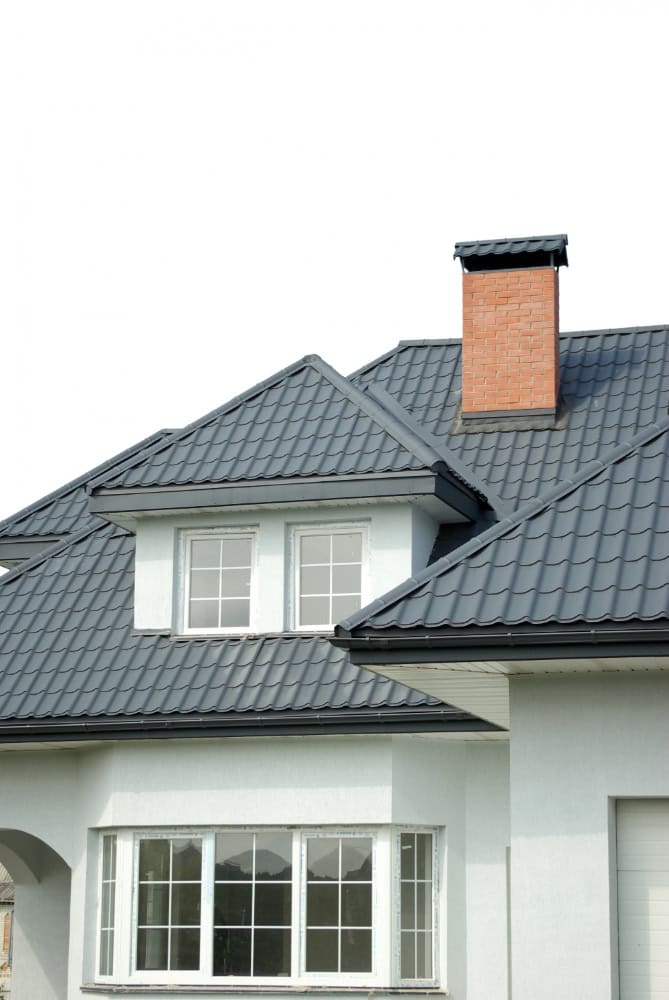 photo of a house with grey roof and white walls